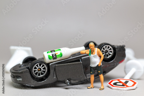 Tableau sur toile A Drunk driver holding a liquor bottle as he steps out of a car