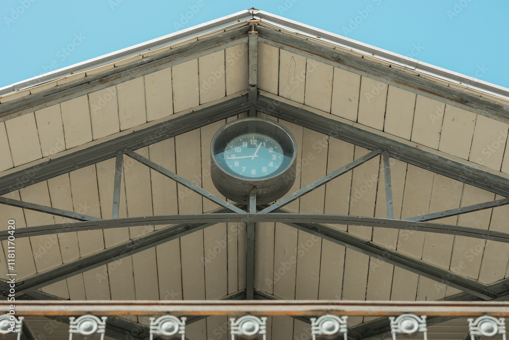 Detail of a time clock on the roof of pula market building, nice ornament, wooden roof and metal railing around