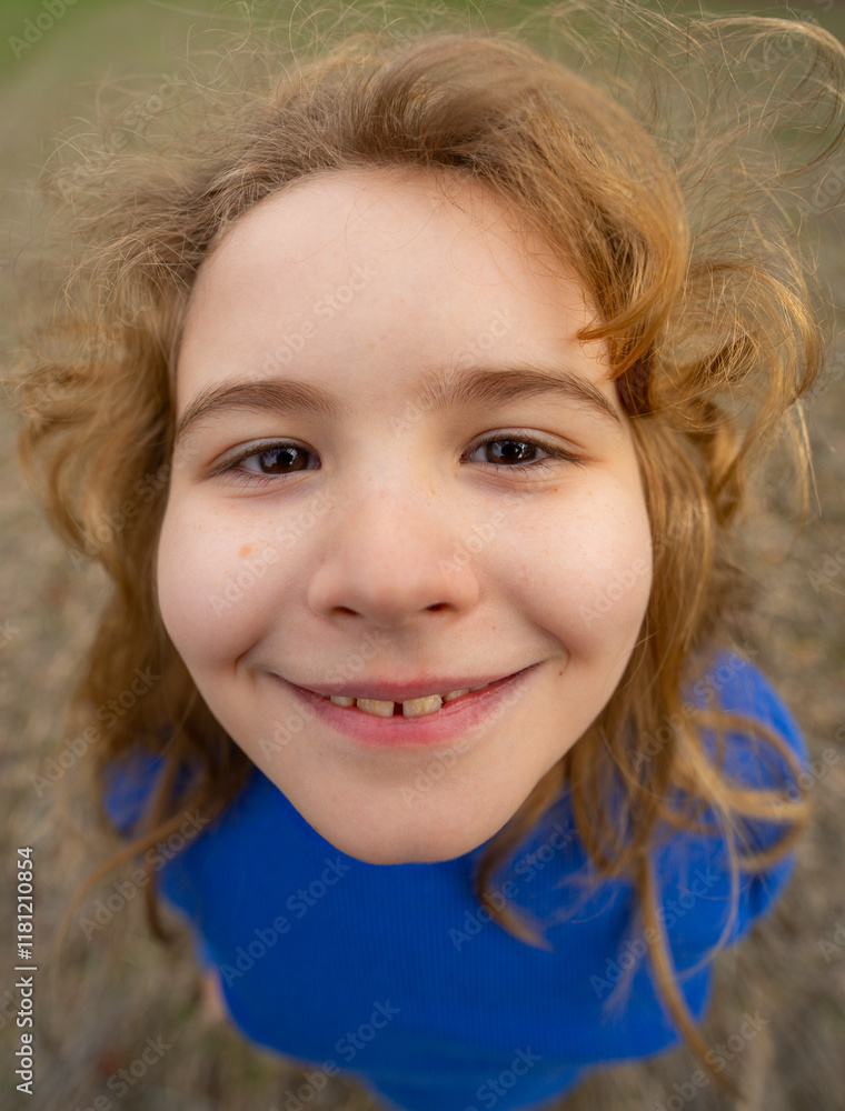 Funny kids face close up. Closeup of kid with blonde hair smiling outdoor. Fun child face. Portrait of funny making funny faces. Portrait crazy and fun. Funny little boy. Kids emotion.