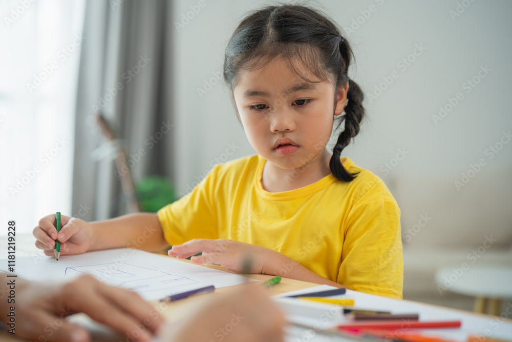 Focused Young Girl Engaged in Creative Drawing Activity at Home, With Arts and Crafts Supplies Spread Across the Table, Emphasizing Childhood Imagination and Engagement in Learning Focused Young Girl Engaged in Creative Drawing Activity at Home, With Arts and Crafts Supplies Spread Across the Table, Emphasizing Childhood Imagination and Engagement in Learning