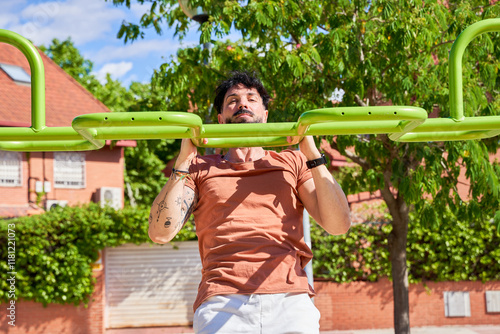 A man engages in a vigorous workout session at an outdoor calisthenics park photo