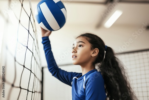 Determined player shows focus and skill during volleyball practice in a gym with faded colors photo