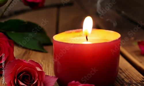 Soft glowing candle creating a cozy and serene ambiance in a dimly lit romantic setting. photo