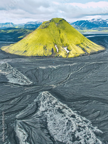 Aerial view of a striking green volcanic mountain surrounded by dark lava fields in Iceland’s highlands photo