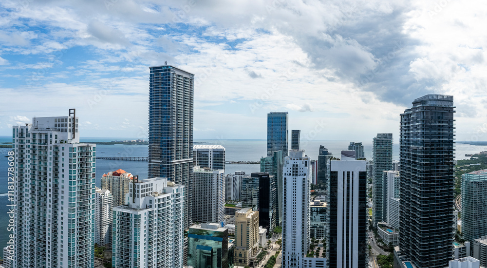 Aerial view of beautiful skyscrapers and Biscayne Bay under a cloudy sky, Brickell, USA. Aerial view of beautiful skyscrapers and Biscayne Bay under a cloudy sky, Brickell, USA.