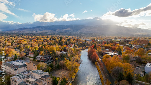 Aerial view of vibrant autumn foliage and serene river with picturesque mountains and cityscape, Downtown Reno, United States. photo