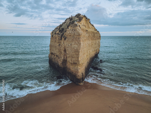 Aerial view of praia da cova redonda with beautiful sea stack and tranquil beach, Porches, Portugal. photo