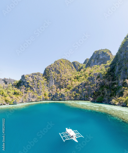 Aerial view of breathtaking turquoise lagoon surrounded by serene cliffs and untouched beaches, Coron, Philippines. photo