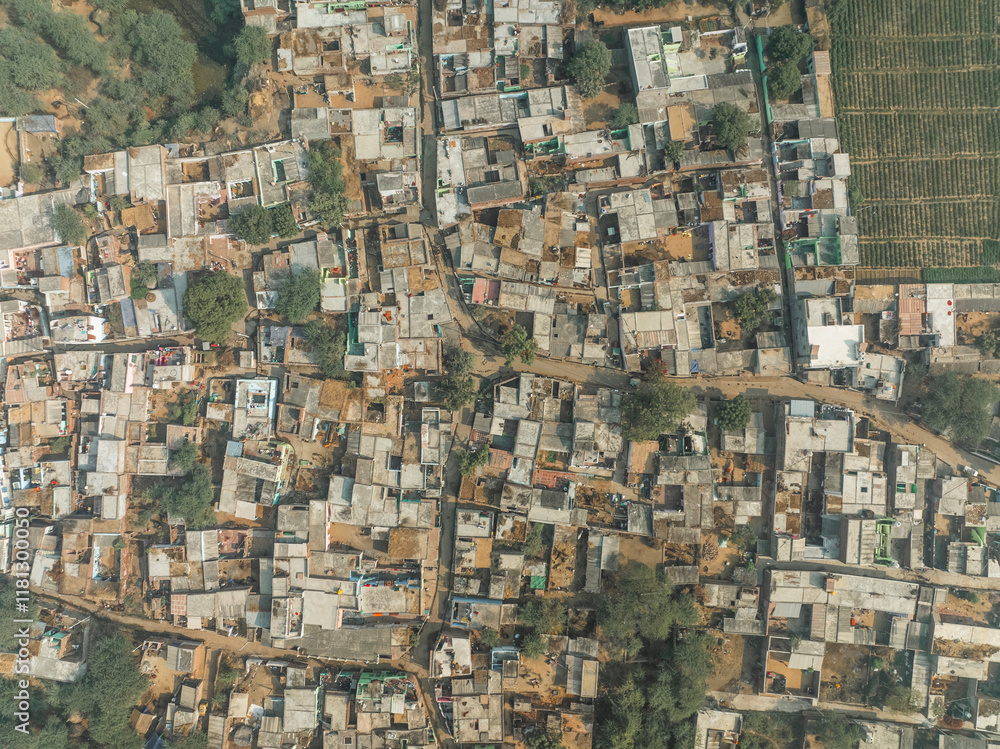 Aerial view of a beautiful village with dense housing and traditional rooftops surrounded by trees, Kiraoli, India. Aerial view of a beautiful village with dense housing and traditional rooftops surrounded by trees, Kiraoli, India.