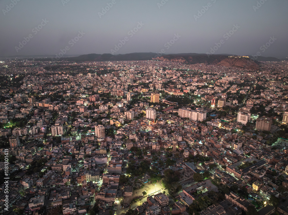 Aerial view of vibrant cityscape at dusk with bustling buildings and skyline, Hasanpura, Jaipur, India. Aerial view of vibrant cityscape at dusk with bustling buildings and skyline, Hasanpura, Jaipur, India.