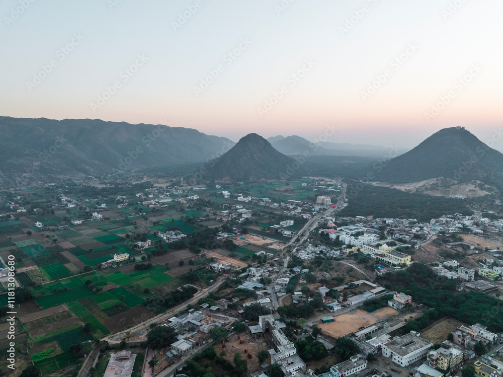 Aerial view of serene sunset over lush valley with homes and fields, Pushkar, India. Aerial view of serene sunset over lush valley with homes and fields, Pushkar, India.