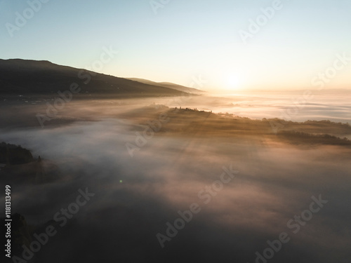 Aerial view of balze valdarno with fog and mist at sunrise, tuscany, reggello, italy.