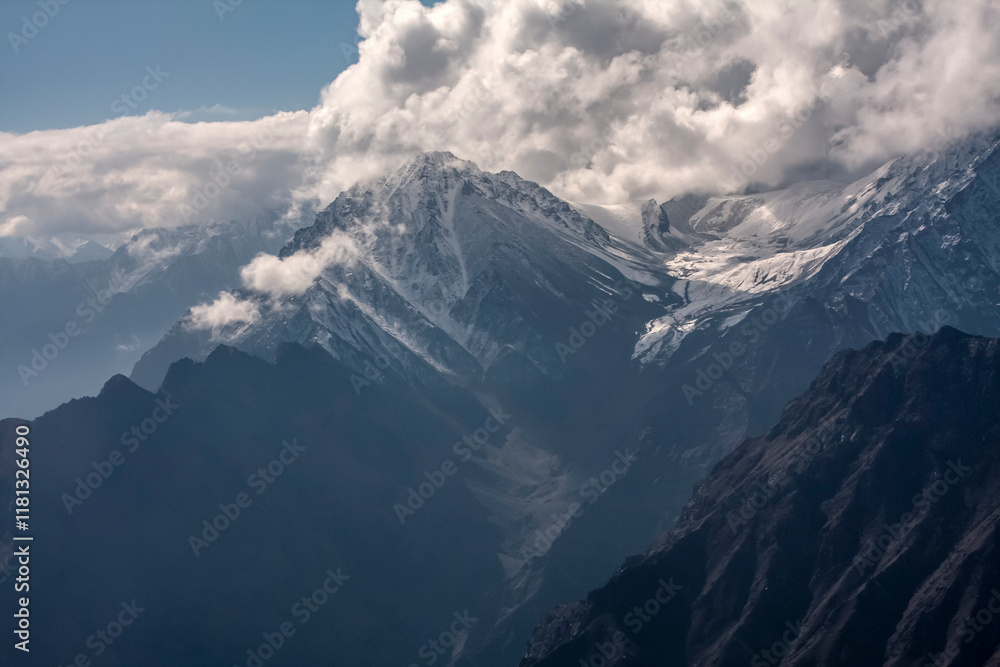 Aerial view of majestic and rugged Himalayan mountain range with snow and clouds, Pakistan. Aerial view of majestic and rugged Himalayan mountain range with snow and clouds, Pakistan.