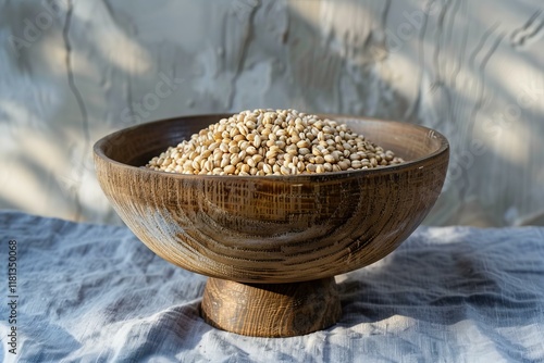 Wooden bowl brimming with job's tears, also known as adlay or coix seeds, creates a rustic and healthy culinary scene