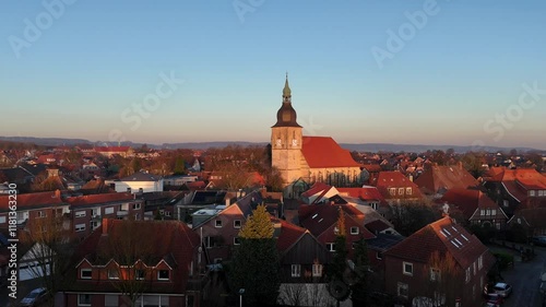 Wallpaper Mural Aerial approaching shot of historic Catholic Church of Nottuln, Germany. Golden sunset time over small German town. Wide shot. Sandstone tower in historic city, Europe. Torontodigital.ca