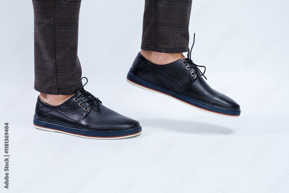 A man is wearing classic black shoes made of natural leather on lace, shoes for men under business style