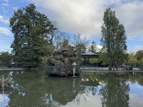 Generated imagePicturesque Lake with Rock Island and Trees Montélimar