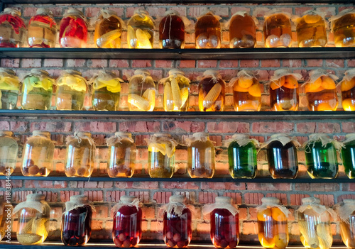 Obraz na płótnie Canned vegetables and fruits in large glass jars on display. Homemade pickles and marinades. w salonie