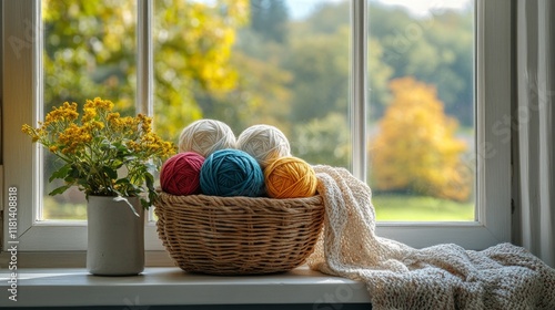 Cozy yarn basket by the window with autumn view and blooming flowers