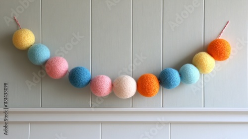 Creative felt ball garland decorates a wooden wall for festive occasions and ...