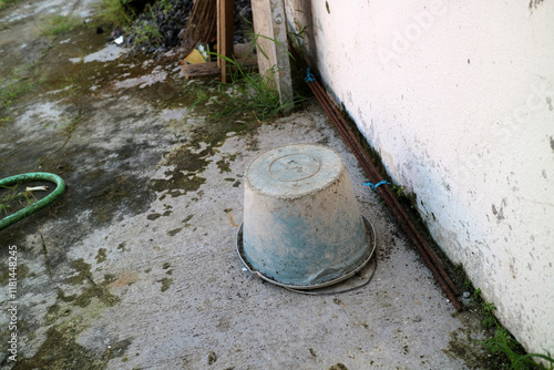 Dirty used cement bucket, upside down outside