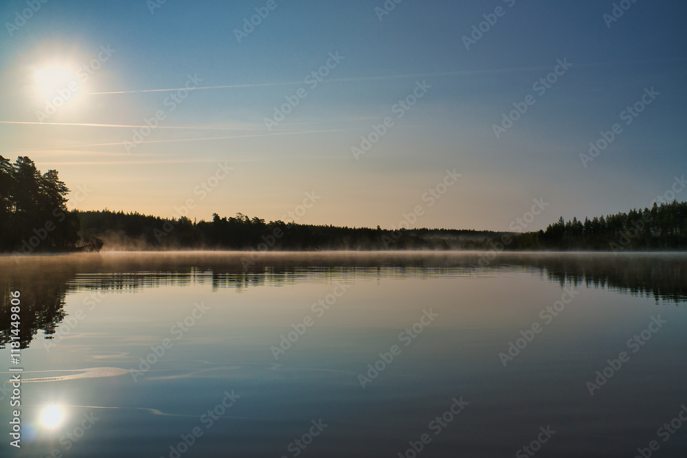 Lake in Sweden, mirror-smooth water with romantic light and trees on the shore Lake in Sweden, mirror-smooth water with romantic light and trees on the shore