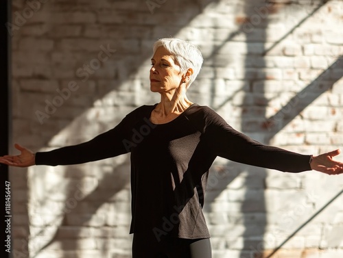 Serene senior woman practicing mindfulness and yoga in sunlit room