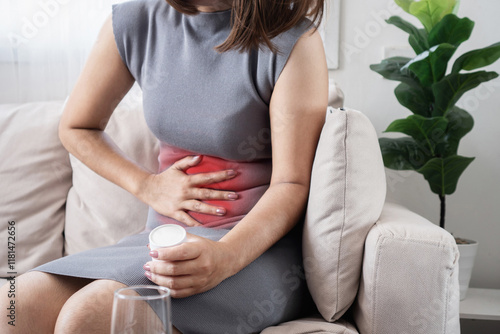 woman suffering from abdominal cramps and diarrhea, potential symptoms of Gastroenteritis or Helicobacter pylori infection photo