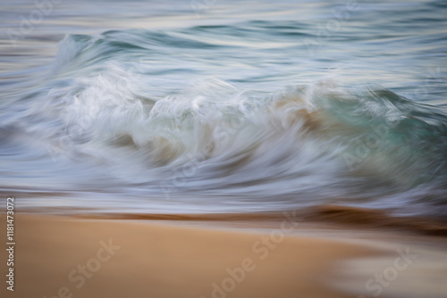 Beautiful morning wave in motion on the beach shore. photo