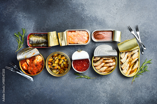 A set of canned seafood: sprats, caviar, mussels, tuna and salmon. Food stocks. On a gray concrete background. photo