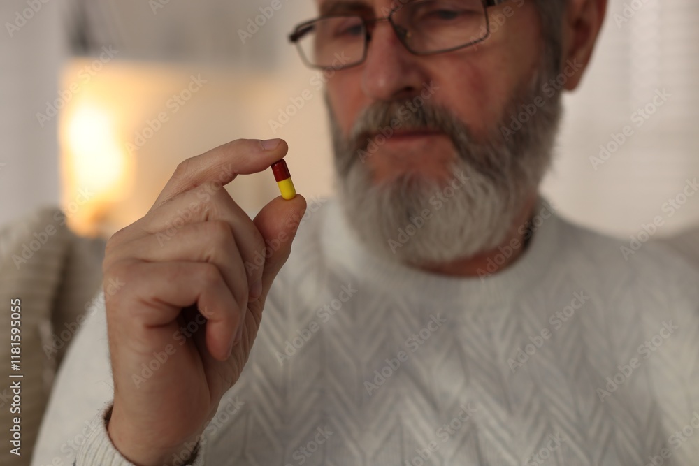 Senior man with pill at home, closeup Senior man with pill at home, closeup