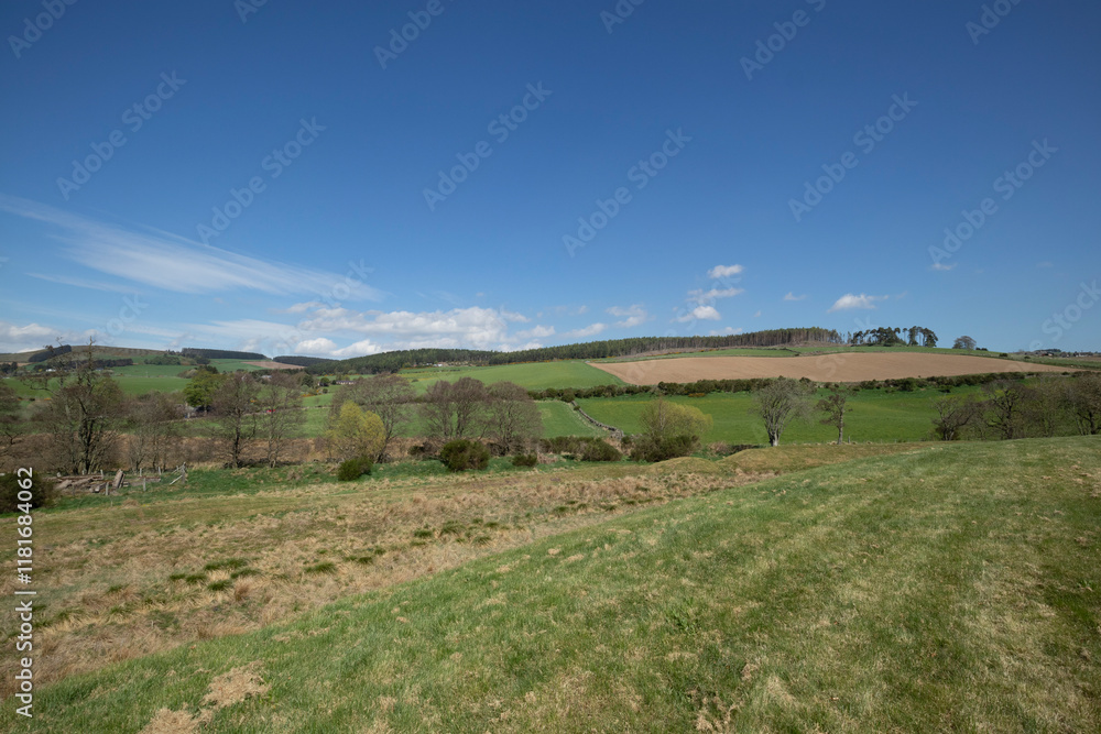 Explore the ancient earthworks in Scotland under a bright blue sky and scattered clouds during a tranquil afternoon Explore the ancient earthworks in Scotland under a bright blue sky and scattered clouds during a tranquil afternoon