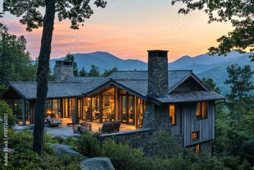 A picturesque mountain home with weathered wood siding, stone chimneys, and a glowing interior framed by twilight