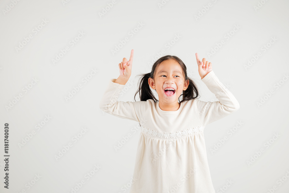 Asian happy portrait cute young kid girl makes gesture fingers point upwards above presenting product something, studio shot isolated on white background, kindergarten children woman smile Asian happy portrait cute young kid girl makes gesture fingers point upwards above presenting product something, studio shot isolated on white background, kindergarten children woman smile