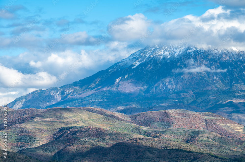 Fototapeta premium Snow topped mountains and green hills around Berat, Albania