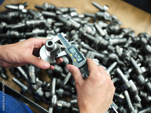 Engineer technician designing drawings mechanical parts engineering Engine
manufacturing factory Industry Industrial work project blueprints measuring bearings caliper tools