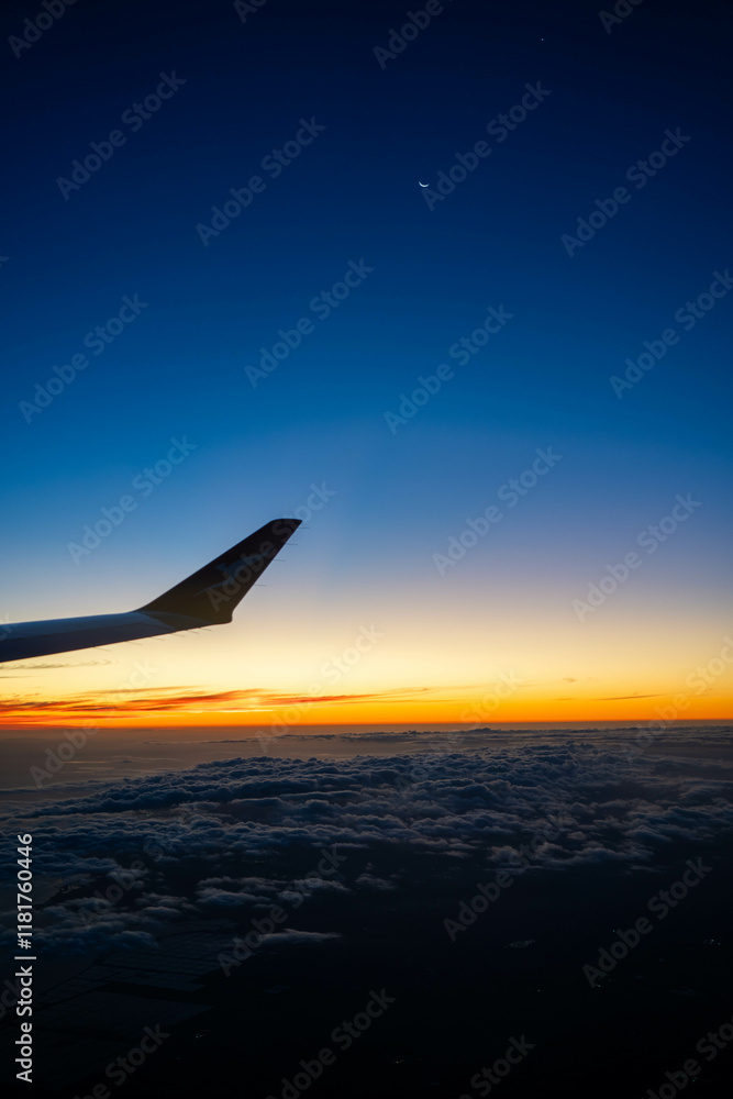 on a plane looking over the wing at sunset on a plane looking over the wing at sunset