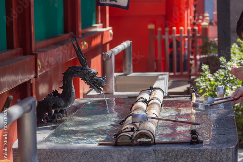 a dragon shaped sculpture and bamboo ladles at chozuya in kanda myojin shinto shrine in chiyoda city