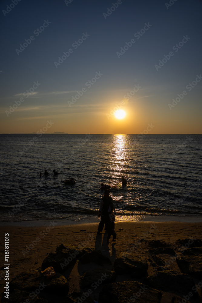 breathtaking sunset over a calm ocean, with the sun casting golden reflections on the water and silhouettes of people enjoying breathtaking sunset over a calm ocean, with the sun casting golden reflections on the water and silhouettes of people enjoying