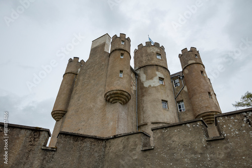 Historic Braemar Castle stands tall against a dramatic cloudy sky in Scotland photo