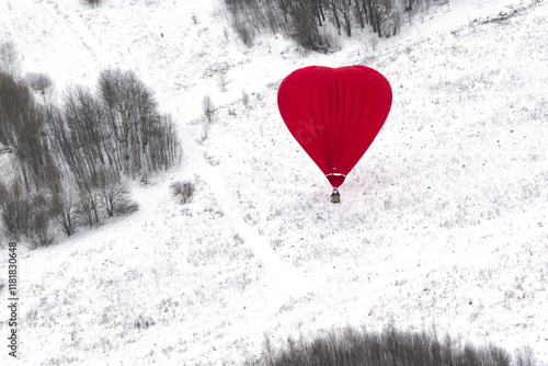 A heart-shaped hot air balloon on the winter field