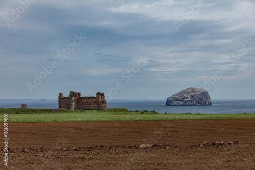 Tantallon Castle overlooking the North Sea with Bass Rock in the distance under overcast skies photo