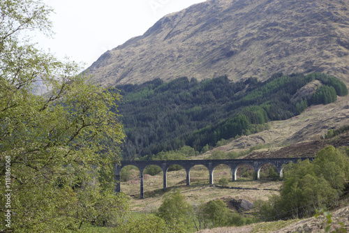 Scenic view of a historic viaduct surrounded by green hills in Scotland during daytime photo