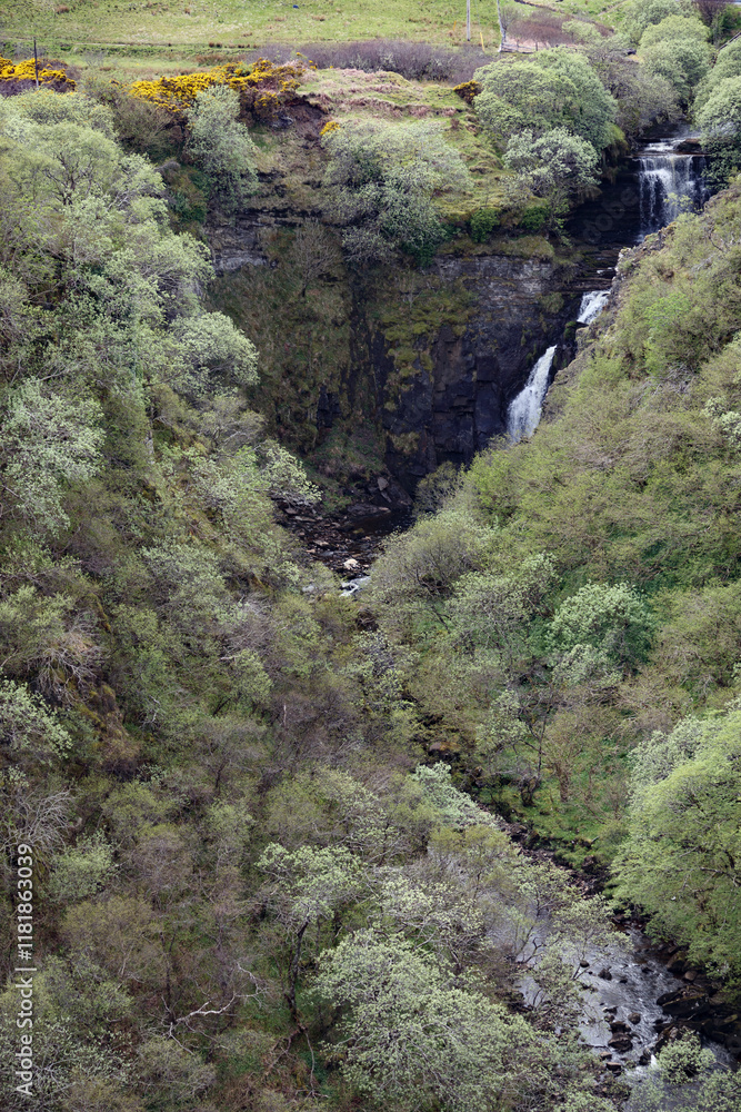 Waterfalls cascading through the lush green hills of Isle of Skye in Scotland during springtime Waterfalls cascading through the lush green hills of Isle of Skye in Scotland during springtime