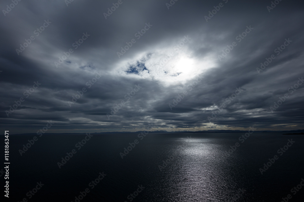 Fototapeta premium Dramatic clouds over the sea at Isle of Skye, Scotland, highlighting nature's power and beauty during twilight hours