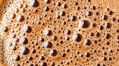 Close-up of cappuccino foam, showing delicate air bubbles and intricate cocoa powder patterns photo