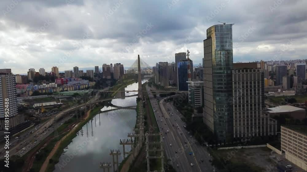 Drone shot over riverside skyline with modern skyscrapers under a cloudy sky at Sao Paulo, Brazil Drone shot over riverside skyline with modern skyscrapers under a cloudy sky at Sao Paulo, Brazil