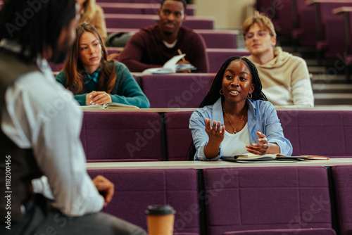 Photography University student asking question during lesson in lecture hall