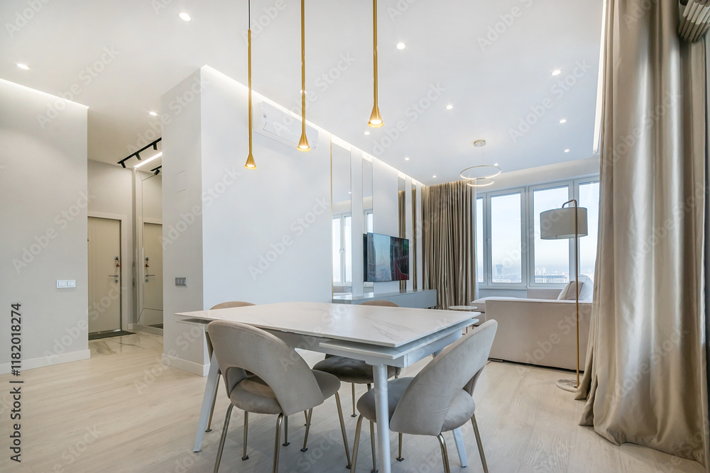 Laconic interior design of a modern studio apartment with a panoramic view from the window. The room is furnished in pastel colors. Laconic interior design of a modern studio apartment with a panoramic view from the window. The room is furnished in pastel colors.