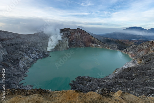 Sulfur smoke rising from Ijen crater over acid lake in Java island Indonesia photo